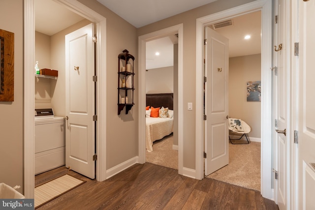 hallway featuring dark hardwood / wood-style flooring and washer / clothes dryer