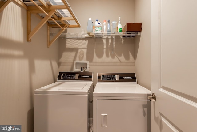 clothes washing area with washer and clothes dryer