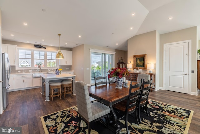 dining area featuring dark wood-type flooring, plenty of natural light, and lofted ceiling