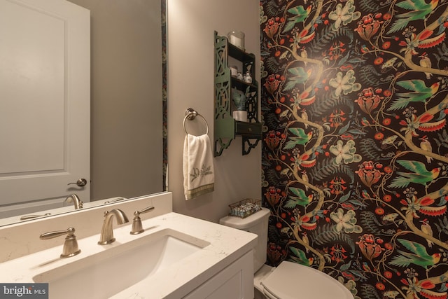 bathroom featuring vanity and toilet