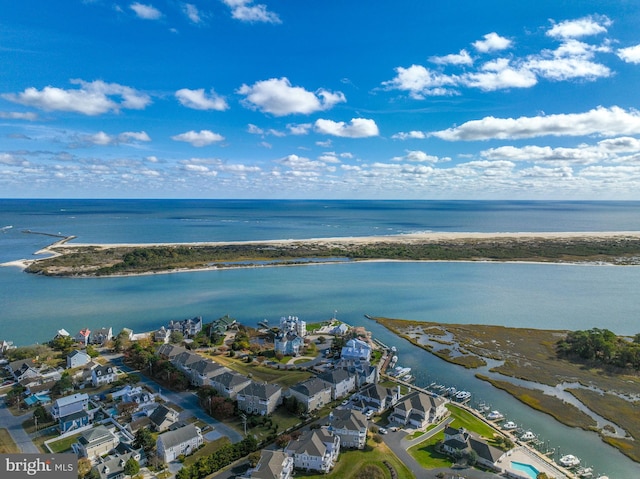 bird's eye view with a water view and a beach view