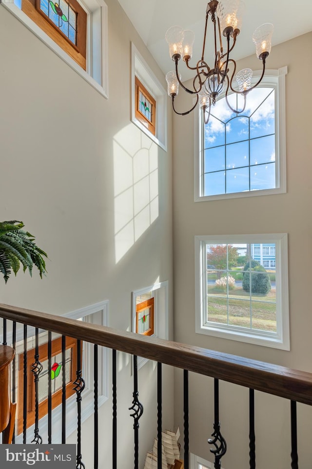 stairway with an inviting chandelier