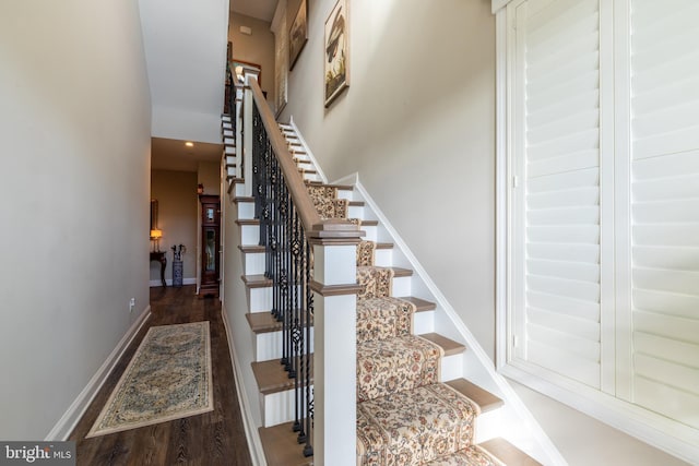 stairs featuring hardwood / wood-style flooring