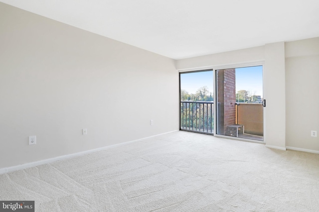 unfurnished room featuring light carpet