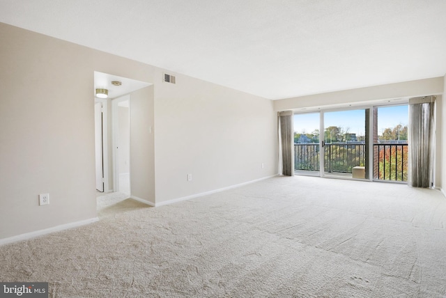 unfurnished room featuring light carpet