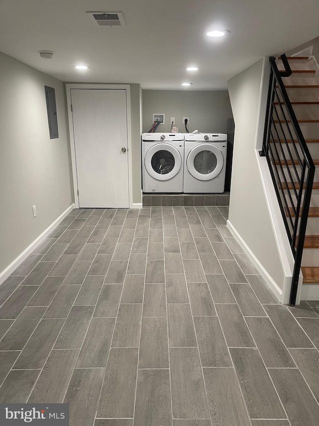 laundry area with washing machine and dryer and dark hardwood / wood-style flooring