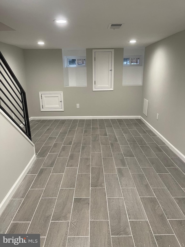 basement with dark hardwood / wood-style flooring