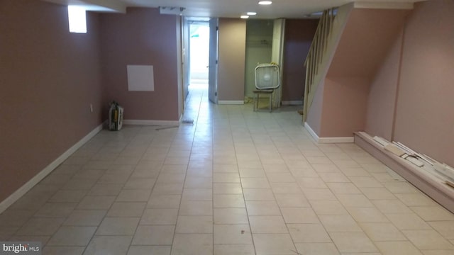 basement featuring light tile patterned flooring