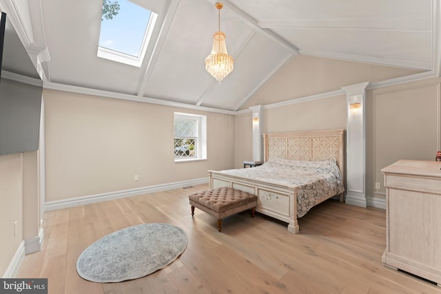 bedroom with vaulted ceiling with skylight, an inviting chandelier, and light wood-type flooring