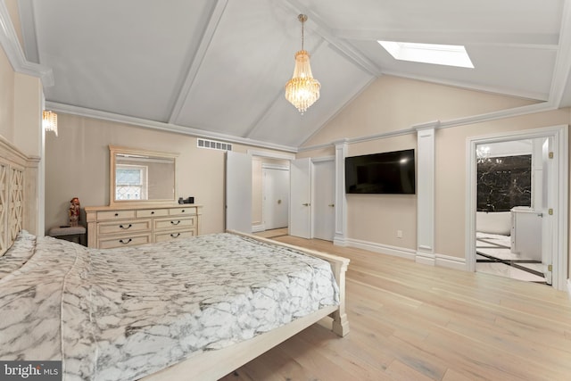 bedroom featuring light wood-type flooring, vaulted ceiling with skylight, and crown molding