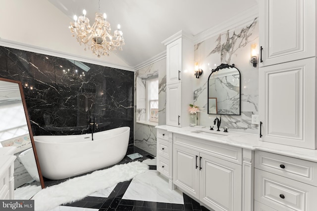 bathroom with a tub, vaulted ceiling, an inviting chandelier, tile walls, and vanity