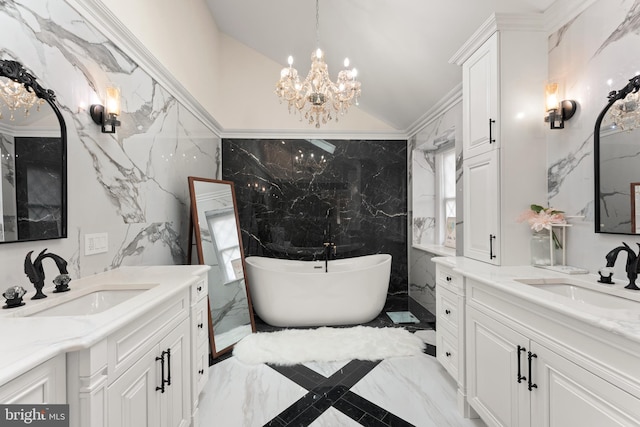 bathroom featuring tile walls, a bathtub, vanity, and an inviting chandelier