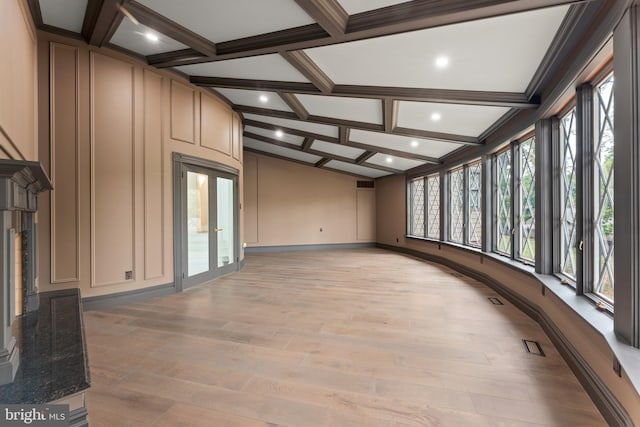 unfurnished sunroom with coffered ceiling and beamed ceiling