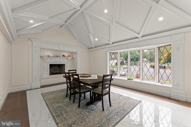 dining space with lofted ceiling with beams and light wood-type flooring