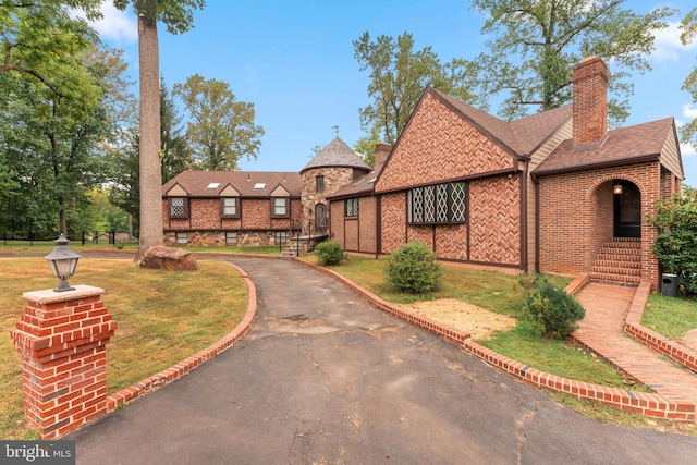 tudor home with a front yard