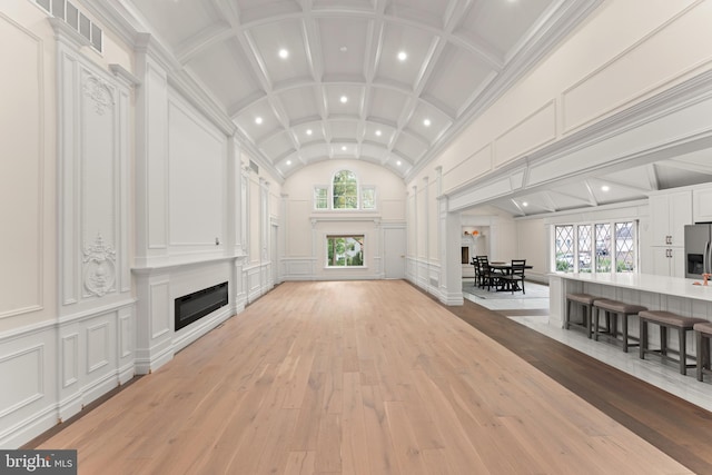 living room featuring light hardwood / wood-style floors and vaulted ceiling