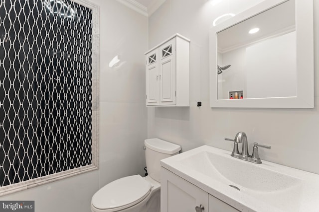 bathroom with a shower, vanity, toilet, and crown molding