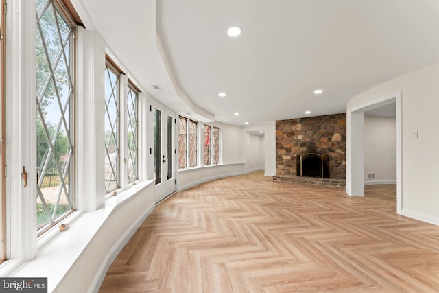 living room featuring a fireplace and light parquet floors