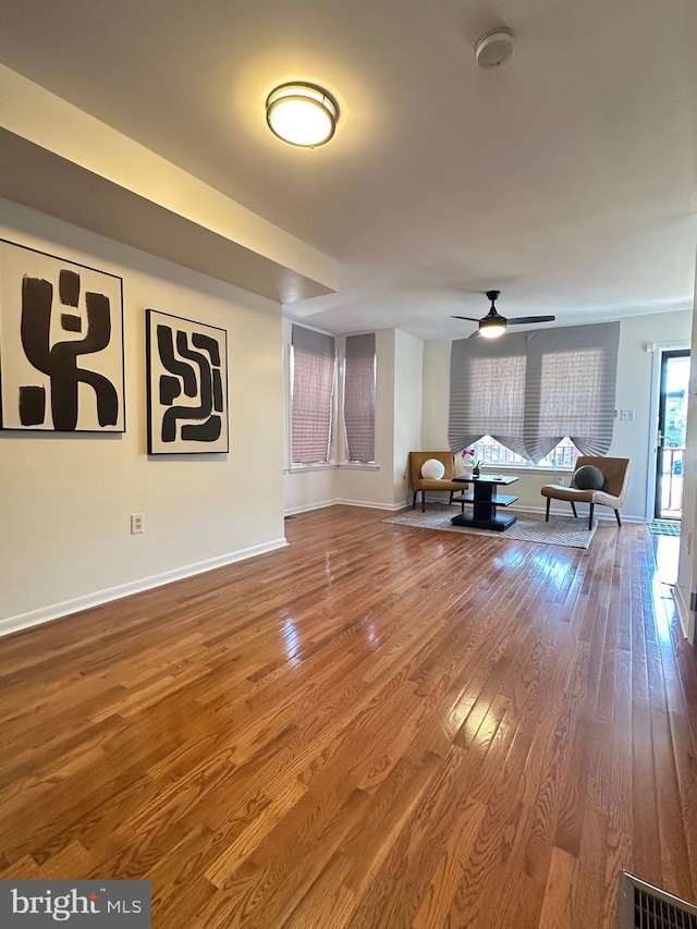 unfurnished living room with hardwood / wood-style flooring and ceiling fan