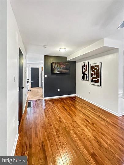 unfurnished room with wood-type flooring