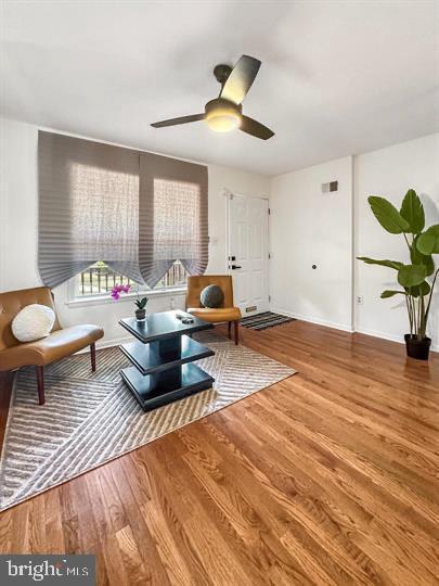 sitting room featuring hardwood / wood-style flooring and ceiling fan