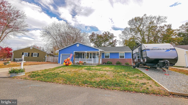 single story home with a front yard and covered porch