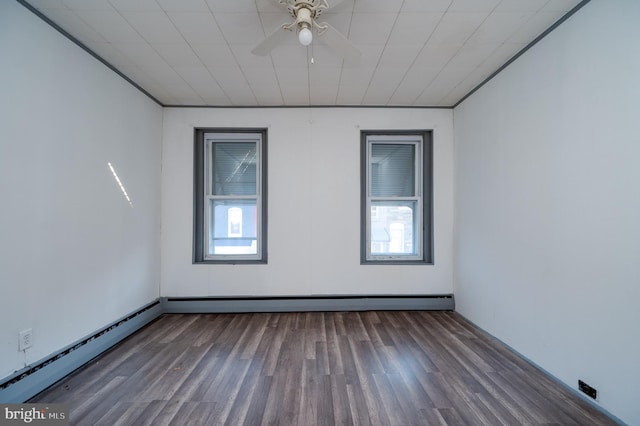 unfurnished room featuring plenty of natural light, ceiling fan, dark wood-type flooring, and a baseboard heating unit