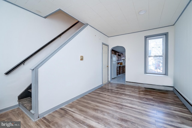 spare room featuring a baseboard radiator and light hardwood / wood-style flooring