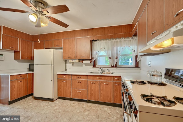 kitchen featuring white appliances, ceiling fan, and sink