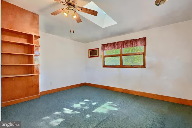 spare room with ceiling fan, carpet, and a skylight