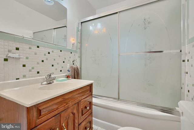 full bathroom featuring vanity, enclosed tub / shower combo, toilet, and tasteful backsplash