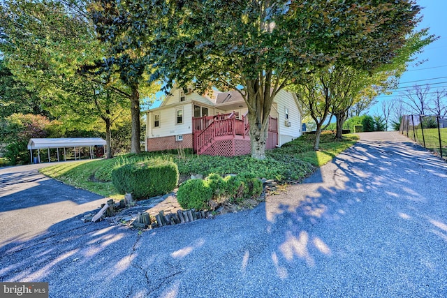 view of front of property featuring a wooden deck and a carport