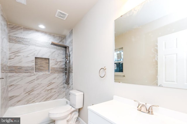 full bathroom featuring vanity, toilet, and tiled shower / bath