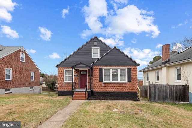 bungalow-style home featuring a front yard