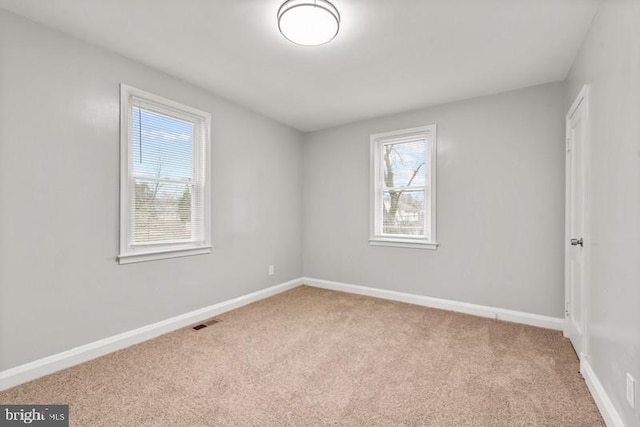 empty room featuring light carpet