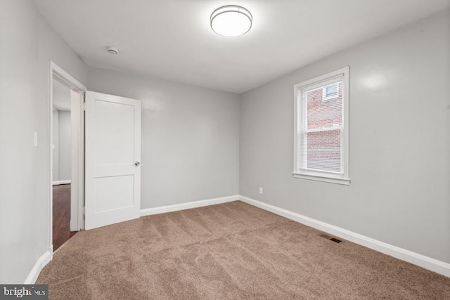 unfurnished room with light carpet