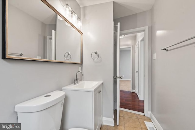 bathroom with vanity, tile patterned floors, and toilet