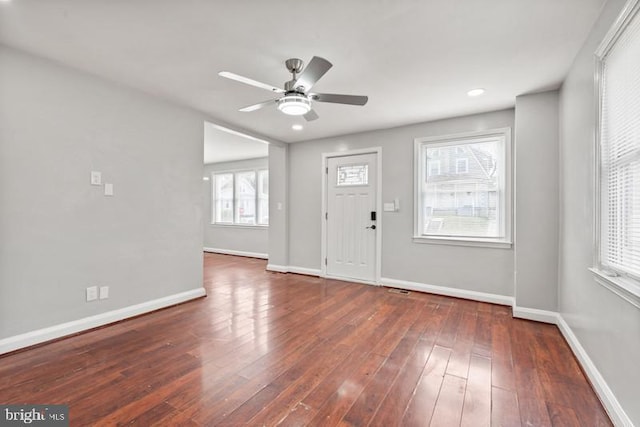 entryway featuring ceiling fan, dark hardwood / wood-style floors, and a healthy amount of sunlight