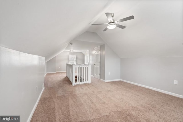 bonus room featuring ceiling fan, lofted ceiling, and light carpet