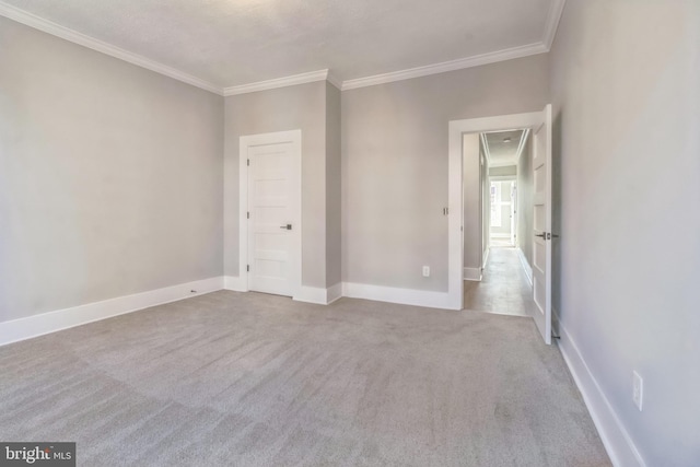 carpeted empty room featuring ornamental molding