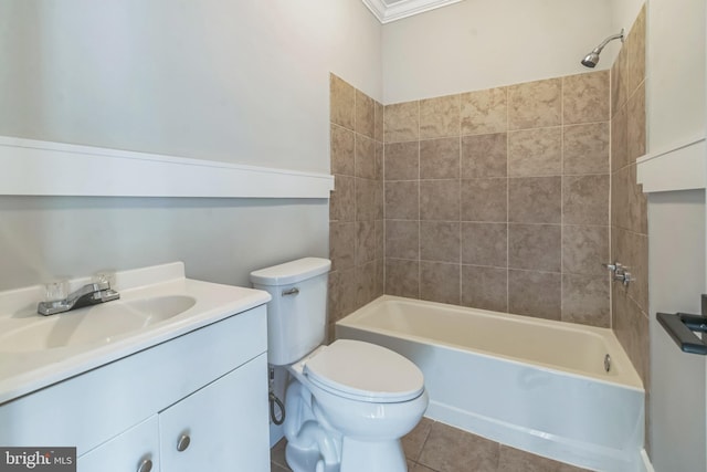 full bathroom with toilet, vanity, crown molding, tiled shower / bath combo, and tile patterned floors