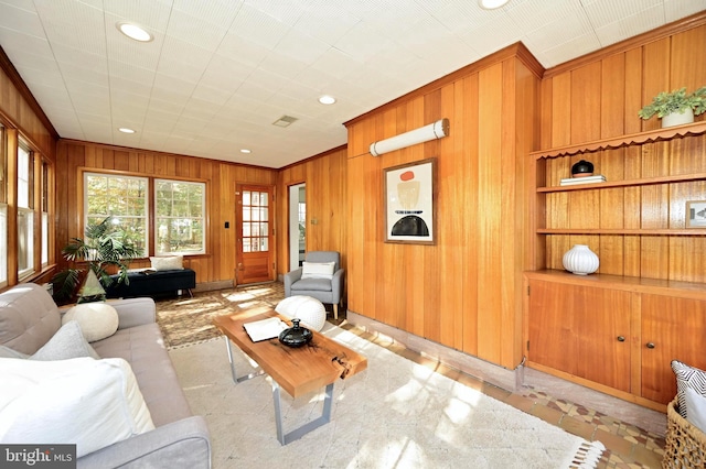 living room with wooden walls and crown molding