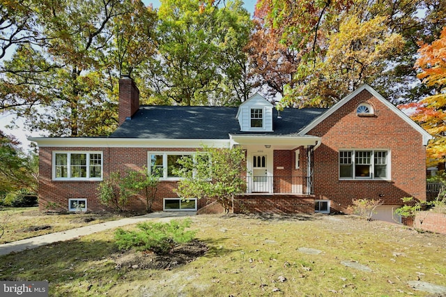 view of front of home featuring a porch, a front lawn, and central AC unit