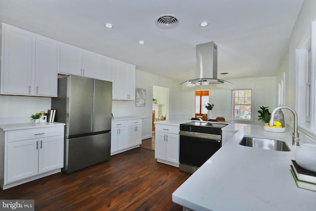 kitchen featuring appliances with stainless steel finishes, sink, island exhaust hood, white cabinets, and dark wood-type flooring