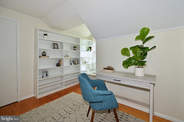 office with built in desk, lofted ceiling, and wood-type flooring