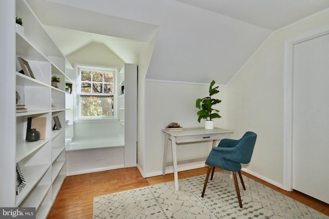 living area with hardwood / wood-style flooring and vaulted ceiling