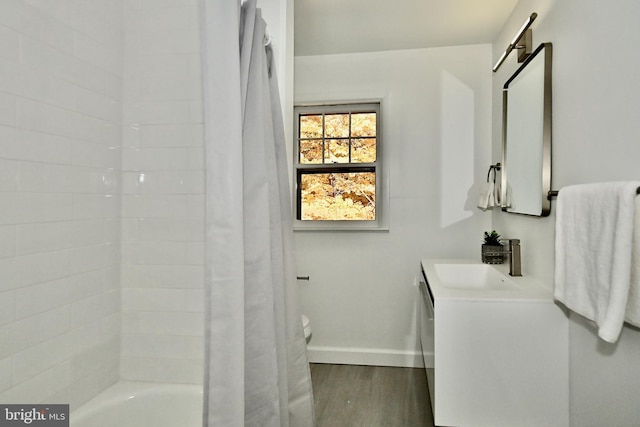 bathroom with vanity, hardwood / wood-style flooring, and shower / bath combination with curtain