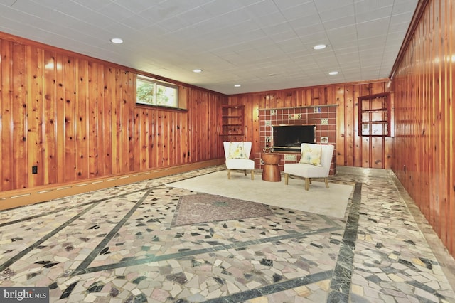 unfurnished room featuring wood walls