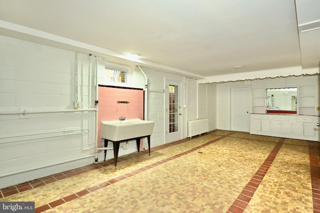 interior space featuring sink and radiator heating unit