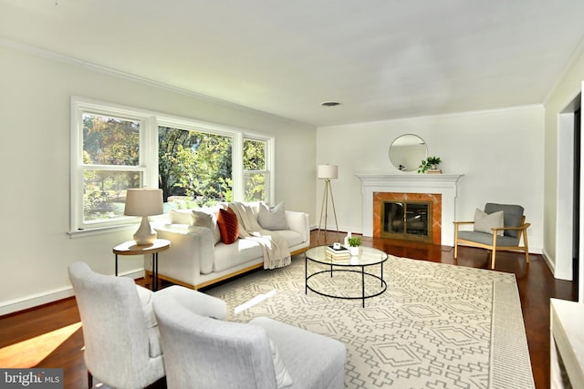 living room featuring crown molding, a fireplace, and hardwood / wood-style floors